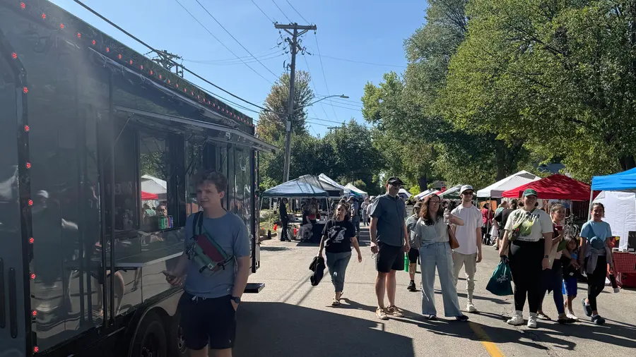 Crowds walking past the trailer at a street festival